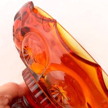 Load image into Gallery viewer, Gorgeous vintage pressed glass amberina Moon and Stars pedestal lidded compote or candy dish. Crafted by the LE Smith Glass Company between 1940s – 2004. This beauty glows brilliantly under black light. This classic candy dish will make a fabulous addition to your glass collection.
In as found vintage condition. The compote is in excellent condition, no chips. The lid has chipping at the rim in several places, see photos.
Measures 6 3/8 x 10 inches