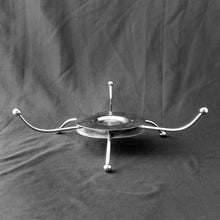 Load image into Gallery viewer, A great mid-century divided glass relish tray perched atop a silver atomic style chrome stand. This is a class cut glass dish with a botanical theme. Perfect for serving crudités with your favourite dip or an assortment of pickles, lives and pearl onions. In excellent condition, no chips or cracks. Measures 11 1/2 x 2 1/2 inches (incl. stand)