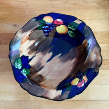 Load image into Gallery viewer, This lovely vintage bowl is hand painted in a rustic style with colourful fruits against a cobalt blue, brown and tan wash ground which is reminiscent of the deep blue sky and farm fields. The bowl is from our personal collection, purchased by my grandmother Rose in the 1930s after she emigrated to Canada. She used this piece as a fruit bowl for many years. In excellent condition, free from chips/cracks. Measures 10" x 2-1/2"