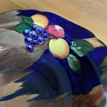 Load image into Gallery viewer, This lovely vintage bowl is hand painted in a rustic style with colourful fruits against a cobalt blue, brown and tan wash ground which is reminiscent of the deep blue sky and farm fields. The bowl is from our personal collection, purchased by my grandmother Rose in the 1930s after she emigrated to Canada. She used this piece as a fruit bowl for many years. In excellent condition, free from chips/cracks. Measures 10" x 2-1/2"