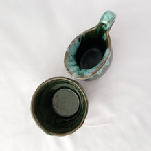 Load image into Gallery viewer, A vintage green drip glaze creamer and open sugar bowl set. The sugar bowl is in the shape of a old fashioned bucket...super cool! The contrast of the colours is outstanding. Produced by McMaster Canada, circa 1970. Excellent condition, no chips or cracks. Creamer measures 4 1/4 x 4 1/4 inches Sugar measures 3 1/2 x 2 1/2 inches