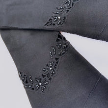 Load image into Gallery viewer, Vintage formal black cotton evening gloves featuring black glass seed bead and cutwork detail with split cuff. The workmanship is impeccable. Likely made in Europe, 1950s. Gorgeous and elegant!
In like new condition, free from stains/tears.
Measures 3 1/8 inches at the widest part of the hand, 4 1/2 inches at the cuff and 12 inches in length.