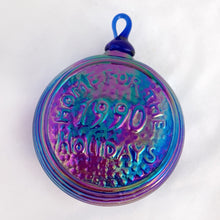 Load image into Gallery viewer, Vintage iridescent blue carnival glass Christmas ornament with house scene on one side and "Home for the Holidays 1990" on the other. The sides have a ribbed detail. A beautiful piece of mold blown glass with an applied blown glass hanger. It's absolutely stunning!  In excellent condition, no chips or cracks. Maker unknown.  Measures 3-1/4" x 1-3/4"