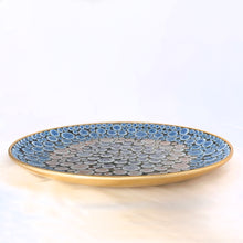 Load image into Gallery viewer, Side view of a vintage 1950s mid-century mosaic tile dish displayed on a a table top, showing circular blue, white, rust and purple tiles with a gold rim