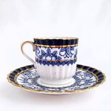 Load image into Gallery viewer, Antique bone china demitasse cup and saucer hand painted in cobalt blue and white florals, geometric band with gold gilt details. The cup has a lovely vertically ribbed or scalloped shape. Crafted by Spode Copeland, England, early 1900s. Gorgeous!
In excellent condition, free from chips/cracks/repairs. Impressed, stamped and painted marks, see photos.
Cup measures 2 x 2 inches, saucer measures 4 1/2 inches