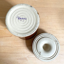 Load image into Gallery viewer, Vintage dark brown glazed pottery storage crock with wire bail closure. Maker unknown. Made in the USA and marked 1059¢ on the bottom. Take the lid off and repurpose as a pencil/pen/make-up brush holder, planter change holder, or use as a decor piece. In excellent condition, free from chips/cracks/repairs. Measures 3-1/4" x 5"