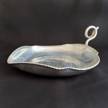 Load image into Gallery viewer, This vintage mid-century modern figural dish in the shape of a leaf features a curled handle a saw-toothed edge. Crafted by BW Buenilum, USA, circa 1950s. Use as a candy dish, or catchall. The perfect additional to your fall decor!  In good vintage condition with some surface marks and normal age-related wear  Measures 8 3/4 x 6 1/2 inches. Maker's mark on bottom.
