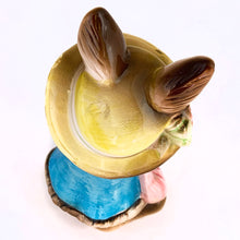 Load image into Gallery viewer, Adorable vintage figural brown bunny rabbit coin bank dressed in blue with a pink purse and yellow hat. Unmarked but likely made in Japan or Taiwan, circa 1970s. In great vintage condition with a flea bite to one of the feet. Measures approximately 6" tall.