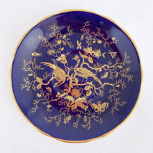 Load image into Gallery viewer, This vintage "Cairo" bone china teacup and saucer is absolutely stunning! Both the cup and saucer are glazed in cobalt blue and overlaid with gold gilt birds, butterflies and florals with a white exterior and gold gilt trim. Produced by Coalport, England, circa 1950. In good condition, free from chips, cracks and repairs. Teacup measures 4" x 2-1/8" | Saucer measures 5-3/4"