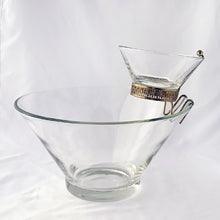 Load image into Gallery viewer, Fabulous vintage mid-century "Modernistic" clear glass chip and dip set with brass-toned metal hanger bracket. The small bowl fits nicely in the hanger bracket which secures it onto the large bowl. Made by Anchor Hocking Glass Co., USA, circa 1950. Entertain in style for movie/game nights or your next party! In excellent condition, free from chips or cracks. Large bowl measures 10 7/8 inches x 5 3/4 inches Small bowl Measures 5 1/4 x 2 1/2 inches