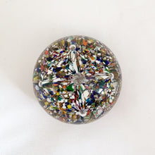 Load image into Gallery viewer, The multitude of colours within the 2 trumpet shaped flowers blown inside this vintage glass paperweight is mind blowing...pardon the pun! Where each petal meets is a controlled bubble that adds an extra sparkle to this beautiful orb shaped paperweight. The bottom has a smoothened pontil mark. Unsigned. In excellent condition, no chips or cracks. Measures 3 x 2 inches