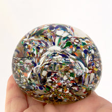 Load image into Gallery viewer, The multitude of colours within the 2 trumpet shaped flowers blown inside this vintage glass paperweight is mind blowing...pardon the pun! Where each petal meets is a controlled bubble that adds an extra sparkle to this beautiful orb shaped paperweight. The bottom has a smoothened pontil mark. Unsigned. In excellent condition, no chips or cracks. Measures 3 x 2 inches