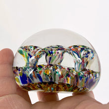 Load image into Gallery viewer, The multitude of colours within the 2 trumpet shaped flowers blown inside this vintage glass paperweight is mind blowing...pardon the pun! Where each petal meets is a controlled bubble that adds an extra sparkle to this beautiful orb shaped paperweight. The bottom has a smoothened pontil mark. Unsigned. In excellent condition, no chips or cracks. Measures 3 x 2 inches