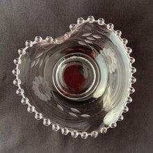 Load image into Gallery viewer, Vintage Imperial Candlewick cut Corn Flower glass heart-shaped candy bowl with 2 sets of 12-petaled flowers and leaf sprays on an Imperial Glass blank. Crafted by WJ Hughes, Canada, 1950s. Show your love with this beautiful crystal heart...even better filled with chocolates, nuts or your favourite temptation. Makes the perfect gift!
In excellent condition, no chips.
Measures 5 inches