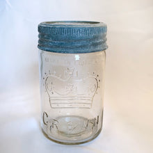 Load image into Gallery viewer, Vintage clear glass Crown mason jar with glass lid and zinc ring closure. The perfect way to store kitchen goods or craft supplies.
Crown mason jars were made in Canada by:
The North American Glass Company 1883 - 1890;
Diamond Glass Company Limited (1890–1902); and
The Dominion Glass Company (1902–1995)
While each jar has its own age-related characteristics, they are all in good vintage condition.
Measures 3 x 6 1/2 inches
Capacity 1 pint