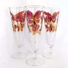 Load image into Gallery viewer, Sip in style with these stunning vintage mid-century era Fred Press footed pilsner glasses decorated in 22kt gold and cranberry pink butterflies on clear Federal Glass blanks, USA, 1950s. Perfect for a cold beer, bubbly champagne or your favourite cocktail or mocktail. These are sure to add a retro glam vibe to your barware!
In excellent condition, no chips.
Measures 2 7/8 x 8 3/8 inches
Capacity 10 ounces