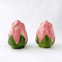 Load image into Gallery viewer, Sweet pair of vintage hand painted "Desert Rose" salt and pepper shakers. Pink and green figural roses. Produced by Franciscan, England, between 1985 - 2003. In great vintage condition. The salt shaker has a minor chip on the inside rim of the bottom lip which can't be seen from the outside (see photos). Each shaker has the original rubber stopper. Measures 2-12" tall.