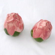 Load image into Gallery viewer, Sweet pair of vintage hand painted "Desert Rose" salt and pepper shakers. Pink and green figural roses. Produced by Franciscan, England, between 1985 - 2003. In great vintage condition. The salt shaker has a minor chip on the inside rim of the bottom lip which can't be seen from the outside (see photos). Each shaker has the original rubber stopper. Measures 2-12" tall.