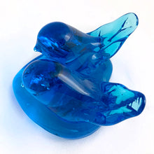 Load image into Gallery viewer, This lovely hand blown azure blue art glass pair of bluebirds perched on a heart was created by artisan Leo Ward in 1992. Mr. Ward was the creator of Arkansas' Bluebird of Happiness and owner of Terra Studios in Arkansas. He passed away at 89 years young in 2017. This piece is in excellent condition, free from chips or cracks. Measures 4" x 4" x 2-1/2"
