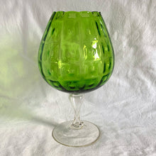 Load image into Gallery viewer, Vintage mid-century hand blown optic art glass snifter features a funky pattern of squares and circles in striking emerald green with a clear stem. Crafted in the Empoli Region of Italy 1950 - 1970, imported by Giftcraft to Canada. The perfect compliment to enhance your MCM decor.
In excellent vintage condition, no chips or cracks. Original sticker.
Measures 8 1/2 x 15 inches