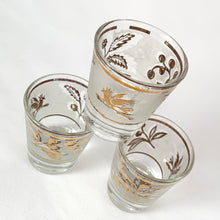 Load image into Gallery viewer, Vintage mid-century shot glasses featuring gold birds and botanicals on a frosted band with gold bands! Perfect to dress up a bar cart, bottoms up!
All pieces are in good vintage condition, no chips or cracks.
Each glass measures 1 5/8 x 2 1/2 inches
Capacity 1 ounce