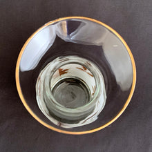 Load image into Gallery viewer, Vintage mid-century era Golden Foliage glass half carafe, decorated with a band of white with gold leaves and gold trim. Crafted by Libbey Glass, USA, 1953 - 1978. Add some Hollywood glam to your barware collection!
In excellent condition, no chips.
Measures 3 1/8 x 7 1/2 inches
Capacity 16 ounces