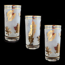 Load image into Gallery viewer, Set of eight mid-century vintage Golden Foliage highball glasses in brass carrying caddy with spiral handle. Produced by the Libbey Glass Company between 1953 - 1978. These glasses will elevate any bar cart and are perfect for any occasion or cocktail! Great vintage condition. The glasses are free from chips/cracks. Minor wear present to the gold on the rim. Each glass measures 2-3/4" x 5-1/2" (12oz)
