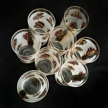 Load image into Gallery viewer, Set of eight mid-century vintage Golden Foliage highball glasses in brass carrying caddy with spiral handle. Produced by the Libbey Glass Company between 1953 - 1978. These glasses will elevate any bar cart and are perfect for any occasion or cocktail! Great vintage condition. The glasses are free from chips/cracks. Minor wear present to the gold on the rim. Each glass measures 2-3/4" x 5-1/2" (12oz)