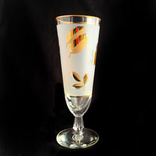 Load image into Gallery viewer, Vintage Golden Foliage pilsner or champagne glass featuring gold leaves on a frosted band bordered by gold bands. Crafted by Libbey Glass, USA, circa 1960s. A fabulous addition to your barware collection.
In excellent vintage condition, no chips.
Measures 3 x 8 1/8 inches