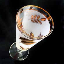 Load image into Gallery viewer, Vintage Golden Foliage pilsner or champagne glass featuring gold leaves on a frosted band bordered by gold bands. Crafted by Libbey Glass, USA, circa 1960s. A fabulous addition to your barware collection.
In excellent vintage condition, no chips.
Measures 3 x 8 1/8 inches