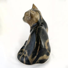Load image into Gallery viewer, Highly desirable and collectible, this sweet vintage ceramic seated grey/brown striped tabby cat figurine has striking amber cathedral glass eyes (if you look at the eyes and move, the eyes will follow you). Produced by artist Mike Hinton, England (retired from Winstanley). In excellent condition, free from chips/cracks. Signed by the artist and marked with the # 33 and England. Dimensions: 5-1/4" x 3-3/4" x 5-3/4"