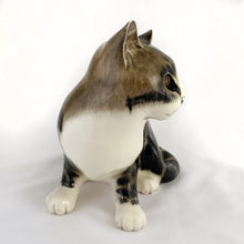 Load image into Gallery viewer, Highly desirable and collectible, this sweet vintage ceramic seated grey/brown striped tabby cat figurine has striking amber cathedral glass eyes (if you look at the eyes and move, the eyes will follow you). Produced by artist Mike Hinton, England (retired from Winstanley). In excellent condition, free from chips/cracks. Signed by the artist and marked with the # 33 and England. Dimensions: 5-1/4" x 3-3/4" x 5-3/4"