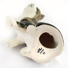 Load image into Gallery viewer, Highly desirable and collectible, this sweet vintage ceramic seated grey/brown striped tabby cat figurine has striking amber cathedral glass eyes (if you look at the eyes and move, the eyes will follow you). Produced by artist Mike Hinton, England (retired from Winstanley). In excellent condition, free from chips/cracks. Signed by the artist and marked with the # 33 and England. Dimensions: 5-1/4" x 3-3/4" x 5-3/4"