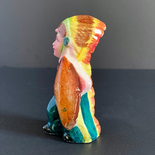 Load image into Gallery viewer, This little First Nations (Native American Indian) shaker is adorably kitschy. He is single and ready to mingle! He's a bit on the peppery side and is looking for a salty companion. Available for all meals. Cork is inside (oops). Made in Japan. The pottery is in excellent condition, no chips or cracks. Extremely nicely glazed, colours are vibrant. Measures 2 1/2 x 2 x 4 inches
