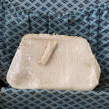 Load image into Gallery viewer, Gorgeous handmade mid-century vintage evening clutch bag covered in a iridescent cream sequins with matching finger strap and kiss closure. The interior is lined with cream coloured satin with a small pocket. The bag is large enough for a cell phone, credit cards/cash. Made in Belgium. An absolutely stunning piece that would make an incredible accessory. In overall excellent condition.