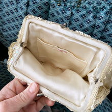 Load image into Gallery viewer, Gorgeous handmade mid-century vintage evening clutch bag covered in a iridescent cream sequins with matching finger strap and kiss closure. The interior is lined with cream coloured satin with a small pocket. The bag is large enough for a cell phone, credit cards/cash. Made in Belgium. An absolutely stunning piece that would make an incredible accessory. In overall excellent condition.
