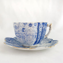 Load image into Gallery viewer, Rare and beautiful antique shell-shaped white bone china, blue "Daisy" teacup and saucer. Produced by JF Wileman, the precursor to Foley and Shelley in England, circa 1889. A must-have for the Foley and Shelley collector! In good condition, free from chips/cracks/crazing. Impressed registration mark "115540" and stamped registration mark "Rd117220" with painted "6021" in gold denoting the pattern name. Some wear to the gold. Teacup measures 3 1/2 x 2 1/4 inches Saucer measures 5 1/2 inches