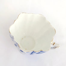 Load image into Gallery viewer, Rare and beautiful antique shell-shaped white bone china, blue "Daisy" teacup and saucer. Produced by JF Wileman, the precursor to Foley and Shelley in England, circa 1889. A must-have for the Foley and Shelley collector! In good condition, free from chips/cracks/crazing. Impressed registration mark "115540" and stamped registration mark "Rd117220" with painted "6021" in gold denoting the pattern name. Some wear to the gold. Teacup measures 3 1/2 x 2 1/4 inches Saucer measures 5 1/2 inches