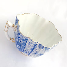 Load image into Gallery viewer, Rare and beautiful antique shell-shaped white bone china, blue "Daisy" teacup and saucer. Produced by JF Wileman, the precursor to Foley and Shelley in England, circa 1889. A must-have for the Foley and Shelley collector! In good condition, free from chips/cracks/crazing. Impressed registration mark "115540" and stamped registration mark "Rd117220" with painted "6021" in gold denoting the pattern name. Some wear to the gold. Teacup measures 3 1/2 x 2 1/4 inches Saucer measures 5 1/2 inches