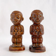 Load image into Gallery viewer, This pair of vintage caramel brown glazed ceramic salt and pepper shakers was designed for the Kon-Tiki Ports Restaurant brand in the 1960s which operated across North America. These naked Hawaiiana figures give the "thumbs up". The perfect addition to your tiki bar or luau party theme. Designed by Steve Crane and produced by M. Kato in Seto Japan. In excellent condition, no chips or cracks. Marked on the bottom. Measures approximately 4-1/2"