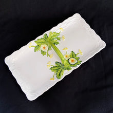 Load image into Gallery viewer, This lovely hand painted vintage majolica divided serving tray has a handle for carrying and the base of the handle has green leaf sprays with yellow daisies. The tray is bordered in a basketweave pattern (shape 4122). This tray is highly collectible and a great example of adorable kitsch ceramics from the mid-century era. Produced by Geo Z. Lefton in Japan. In excellent condition, no chips or cracks. Measures 13 x 7 x 1 1/2 inches