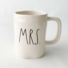 Load image into Gallery viewer, "MRS." off white ceramic mug. Marked on the bottom, Rae Dunn Artisan Collection by Magenta 202. Rae Dunn's designs are instantly recognizable....they are mostly cream-colored tableware, typically emblazoned with one- or two-word phrases using a simple hand-written style font. In excellent condition free from chips/cracks/repairs. Measures 5 x 4 1/2 inches (includes handle) Capacity 16 ounces