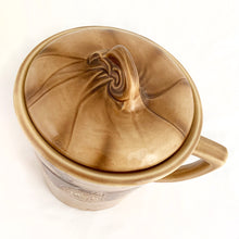 Load image into Gallery viewer, Check out this cool figural ceramic coffee cup shaped cookie jar decorated with steaming cups of hot bevvies and cookies and the lid is super cute with a curled cloud of steam for a handle. Produced by McCoy Pottery in the USA, between 1963-1966. Marked "USA" on the handle. A wonderful collectible to add charm to your kitchen decor or coffee station.
In excellent condition, free from chips/cracks/repairs.
Measures 7 1/2 x 9 1/4 inches