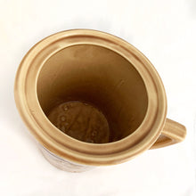 Load image into Gallery viewer, Check out this cool figural ceramic coffee cup shaped cookie jar decorated with steaming cups of hot bevvies and cookies and the lid is super cute with a curled cloud of steam for a handle. Produced by McCoy Pottery in the USA, between 1963-1966. Marked "USA" on the handle. A wonderful collectible to add charm to your kitchen decor or coffee station.
In excellent condition, free from chips/cracks/repairs.
Measures 7 1/2 x 9 1/4 inches