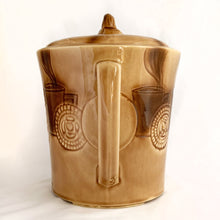 Load image into Gallery viewer, Check out this cool figural ceramic coffee cup shaped cookie jar decorated with steaming cups of hot bevvies and cookies and the lid is super cute with a curled cloud of steam for a handle. Produced by McCoy Pottery in the USA, between 1963-1966. Marked "USA" on the handle. A wonderful collectible to add charm to your kitchen decor or coffee station.
In excellent condition, free from chips/cracks/repairs.
Measures 7 1/2 x 9 1/4 inches