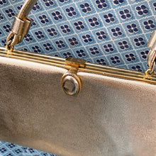 Load image into Gallery viewer, Stunning mid-century vintage gold lamé evening bag with gold toned oval button flip clasp, top strap handle and the interior is lined with gold satin. The bag is large enough for a cell phone, credit cards/cash, small compact/lipstick. Crafted by After Five, USA, 1950s. Adds a dash of Hollywood glam to your fashion statement!
In vintage condition with age-related wear. Maker's mark on the interior.
Measures 7 3/4 x 1 x 5 inches, 5 1/8 inch handle drop