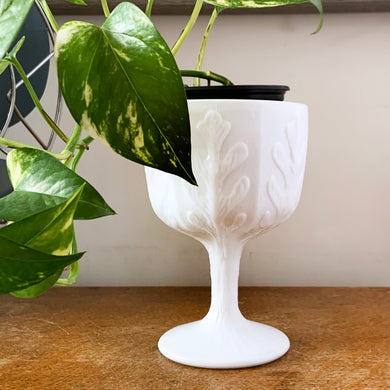 Classic goblet shaped milk glass planter with vertical leaf pattern. Perfect for a pretty floral display, or your favourite house plant. Or repurpose as a candy dish, pencil or make-up brush holder. Produced by FTD.  In excellent condition, no chips or cracks.  Size: 4-1/4