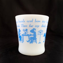 Load image into Gallery viewer, Vintage Fire-King milk glass D-handled mug printed in blue with seated children saying mealtime prayer while their mom serves them with puppy and bird observing. The prayer reads, "I fold my hands and bow my head To thank Thee for my daily bread". Produced by Anchor Hocking Glass Co., USA. In excellent condition, no chips or cracks. Measures 3 1/4 x 3 3/8 inches