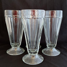 Load image into Gallery viewer, These classic vintage mid-century modern Fountain glass is the real deal, featuring a six panel design, with stippled foot. Crafted by Libbey Glass, Canada, 1950/60s. Perfect for making tasty floats, milkshakes or sundaes.
In excellent condition, no chips. Marked CANADA on the bottom.
Measures 3 1/4 x 7 inches
Capacity 12 ounces