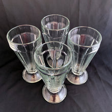 Load image into Gallery viewer, These classic vintage mid-century modern Fountain glass is the real deal, featuring a six panel design, with stippled foot. Crafted by Libbey Glass, Canada, 1950/60s. Perfect for making tasty floats, milkshakes or sundaes.
In excellent condition, no chips. Marked CANADA on the bottom.
Measures 3 1/4 x 7 inches
Capacity 12 ounces